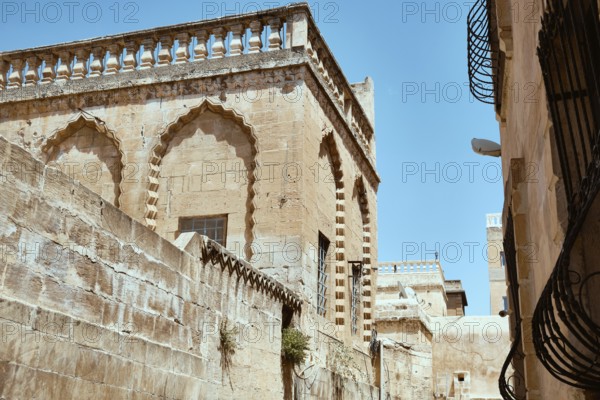 Traditional middle eastern stone houses on a street of Middle Eastern city. Streets of Mardin, Turkey