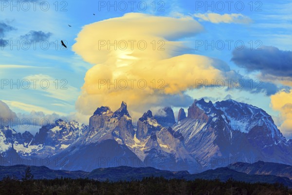 Chile. Torres del Paine National Park. The massive granite towers of Cuernos del Paine. Incredible clouds illuminated by the sunset