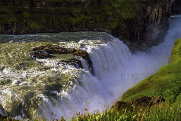 Gullfoss Golden Falls - the most beautiful waterfall in Iceland, on the Hvita River. Above the waterfall there is a constant haze of water. The concept of active, extreme, and photo tourism