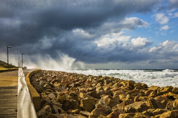 The storm in the Mediterranean Sea. Huge foaming waves beating against the shore. New Quay in the Old Jaffa, Israel