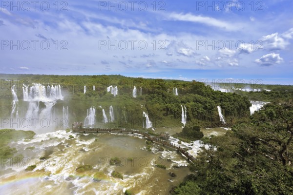 Turbid yellow-brown waves flow down. Raging and roaring water in the Brazilian side of the Iguazu Falls