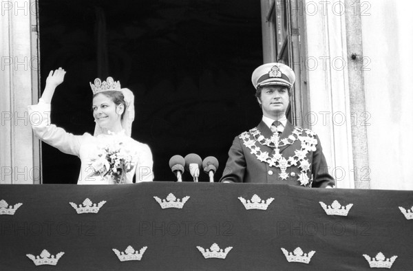 Wedding of Carl XVI Gustaf and Silvia Sommerlath. Carl XVI Gustaf, King of Sweden. Born 30 april 1946. The wedding 19 june 1976 in Stockholm. Queen Silvia in her wedding dress with king Carl XVI Gustaf on the balcony of the royal castle in Stockholm