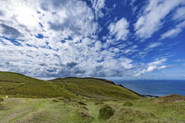 Vast rolling countryside with green meadows and sea views on the edge of Snowdonia National Park, Penmaenmawr, Dwygyfylchi, Caernarfonshire, Conwy County Borough, Wales, United Kingdom