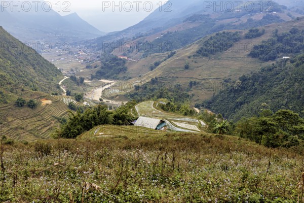 An impressive landscape with green valleys, hills and a meandering river, farms in the rice paddies near Sa Pa in Vietnam