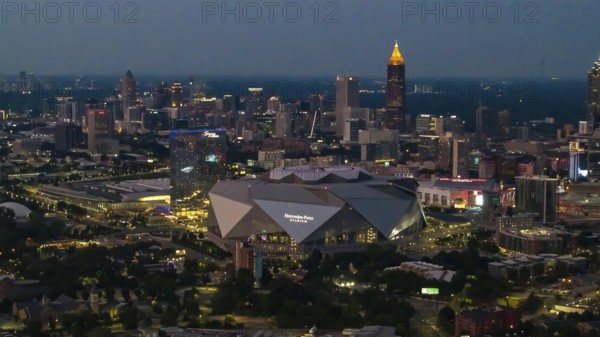 Aerial views of Atlanta showcase a vibrant cityscape with sleek skyscrapers, lush green spaces, and iconic landmarks like Mercedes-Benz Stadium. Highways, railroads, and hills weave through this bustling metropolis, Atlanta, United States of America