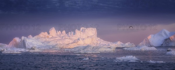 Floating glaciers in the rays of the setting sun at polar night