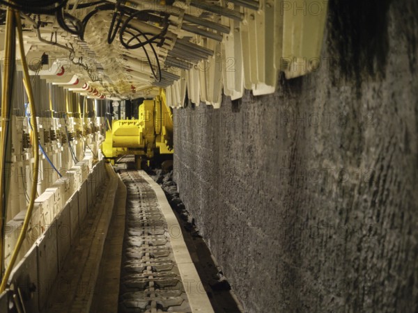 Conveyor belt in tunnel with yellow machine, Bochum, North Rhine-Westphalia, Germany