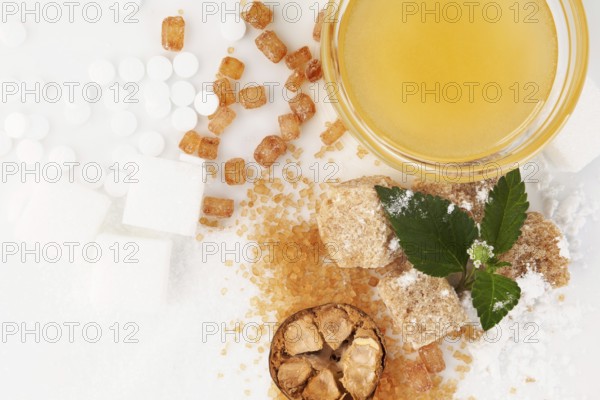 Various types of sugar - brown, white, crystal, powdered and cane sugar, artificial sweetener, monk fruit and honey in bowl
