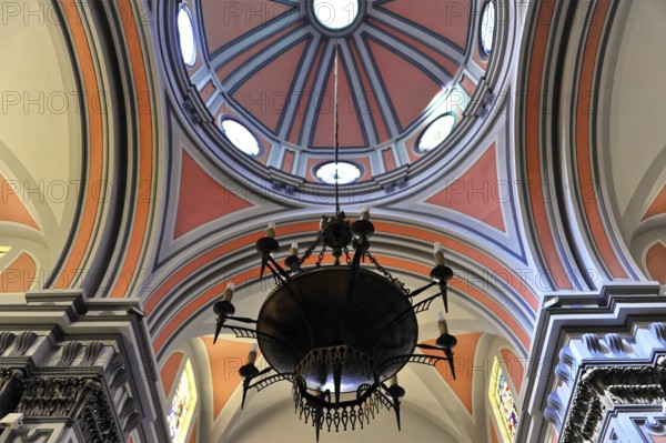 La Merced or Church of Our Lady of Mercy, view of a richly decorated ceiling with dome and a large candelabra, Ronda, Malaga province, Andalusia, Spain