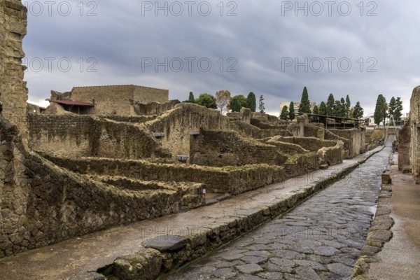 Ercolano, Italy, 25 November, 2023: typical city street and houses in the ancient Roman town of Herculaneum