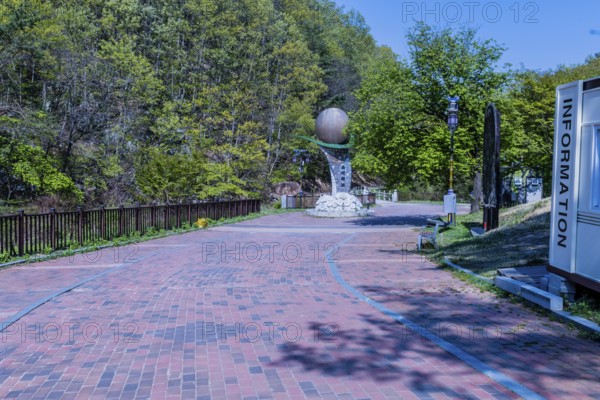 Yongdong, South Korea, April 28, 2020: Sculpture of and red brick walkway at entrance to Okgye Pokpo waterfall park