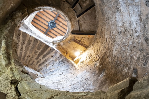 Ancient stairs of snail constructed in stone illuminated by the light of the Sun. Priego de cordoba, Andalucia. Spain
