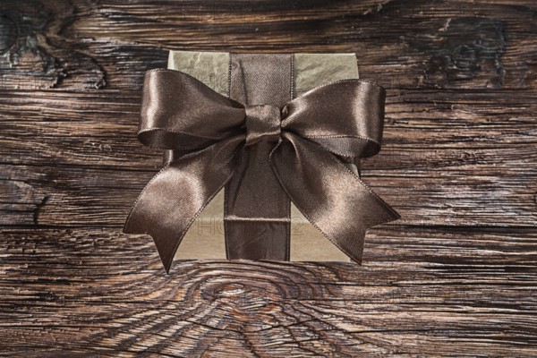 Brown packed gift box on vintage board