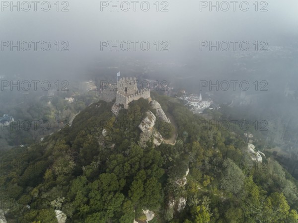 Aerial view of Castelo dos Mouros or Moorish Castle in fog, Sintra, Portugal