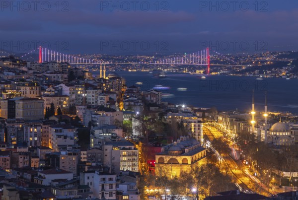 A picture of the buildings of the Beyoglu district and the Bosphorus Bridge at night