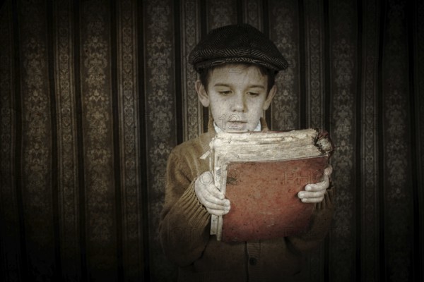 Child with red vintage book. Vintage clothes and hat