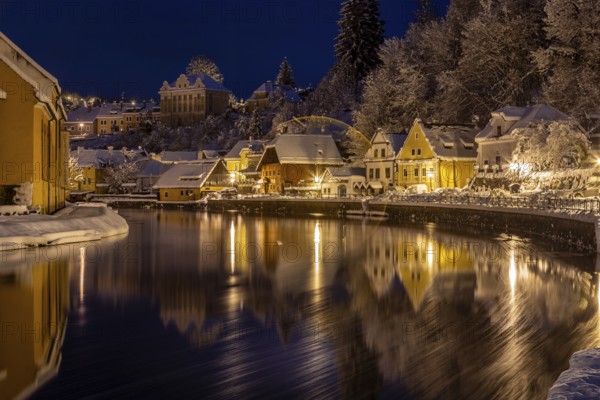 Winter view of Cesky Krumlov, picturesque houses under the castle with snow-covered roofs. Narrow streets and the Vltava river. Travel and Holiday in Europe. Christmas time. UNESCO World Heritage. Czech Republic