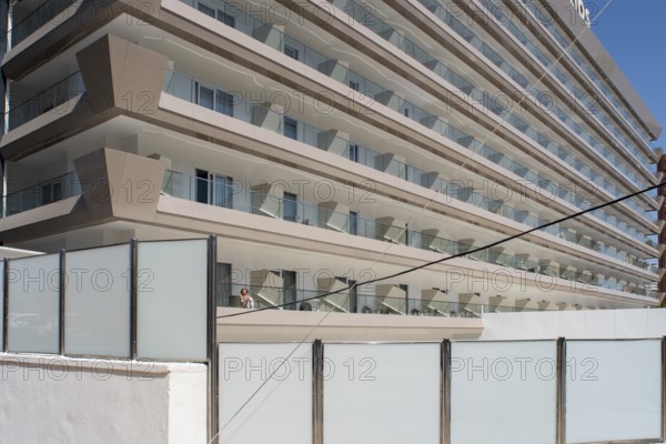 Woman sunbathing on the balcony of Hotel Helios in Benidorm, Alicante province, Spain