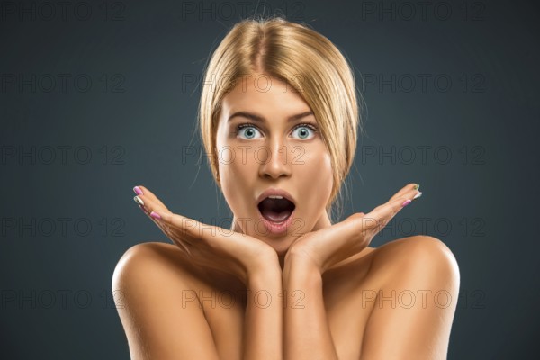 Portrait beautiful blond woman with blue eyes stared into the camera - isolated azure background