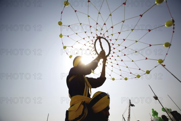 Young Nihangs Sikh warrior performing traditional martial art Gatka consecration perpetual Guru Granth Sahib, Nanded