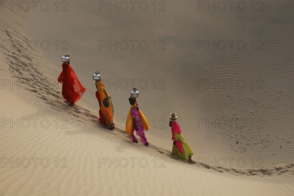 Girls climbing dune, Khuhri, Jaisalmer, Rajasthan, India