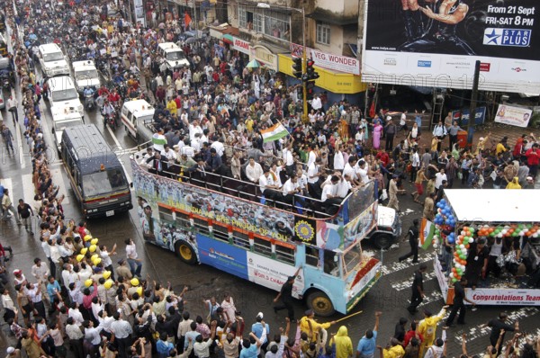 Twenty 20 team wave tri color Indian flags in special decorated bus during victory procession, Bombay Mumbai, Maharashtra, India