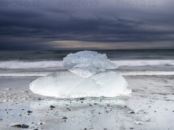 Diamond Beach, iceberg in the surf on the black lava beach, near Jökulsarlon glacier lagoon, Vatnajökull National Park, Hornafjörður, South Iceland, Iceland