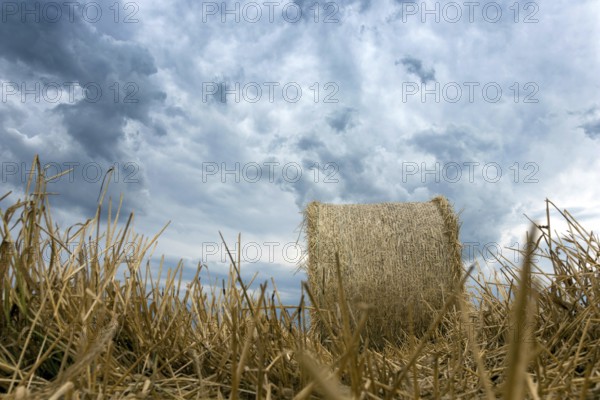 Straw bales on farmland Storm clouds