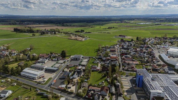 Aerial view of a village with surrounding fields and country road under a cloudy sky, Mitterteich, Upper Palatinate, Bavaria, Germany