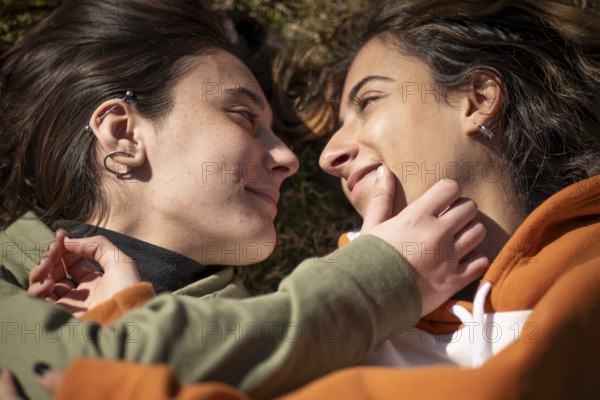 Lesbian about to kiss in a park