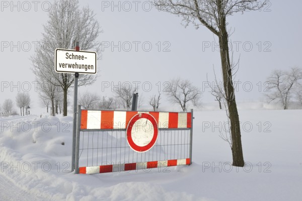 Road blockage through snow drifts. Blocked road