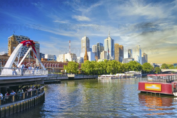 Evening atmosphere in Melbourne on the Yarra River with the Evan Walker Bridge and Flinders Street railway station in Victoria