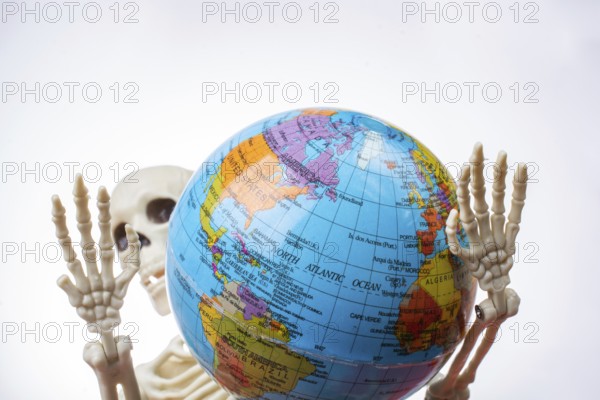 The earth in a skeleton hand