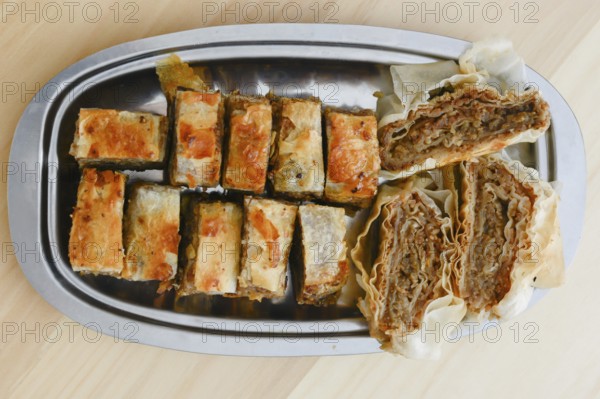 Traditional serbian cake baklava arranged on metal plate for serving on Saint day