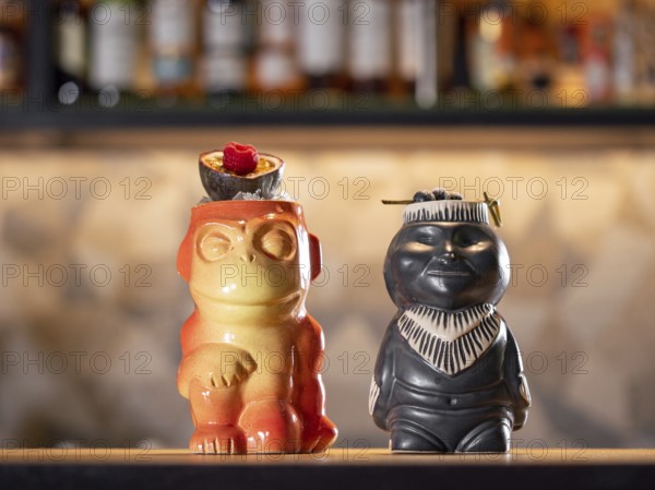 Tiki Drink Cocktails. Two tropical tiki cocktails on bar counter. Tiki cocktails on bar in night club