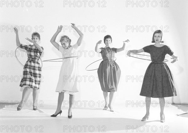 In the 1950s. Women Hula hooping. A craze that culminated during 1958 with some 20 million hula hoop rings sold in less than four months in the USA. Sweden 1958 ref BV18-3