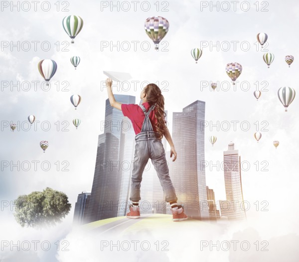 Concept of careless happy childhood with girl dreaming about future