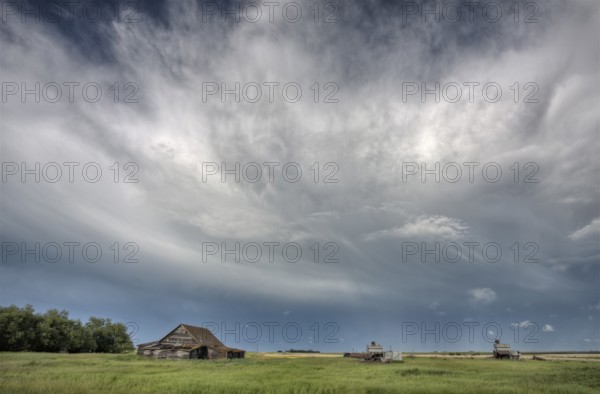 Abandoned Farm with storm clouds in the Canadian Prairie