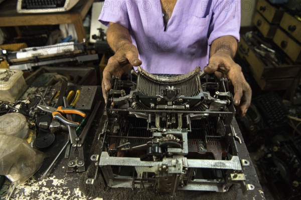 Technician repairing an old manual typewriter Mumbai, Maharashtra, India, Asia