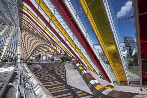 Colourful glass roof adorns the sides of a modern railway station with a view of the city, Liège, Wallonia region, Belgium