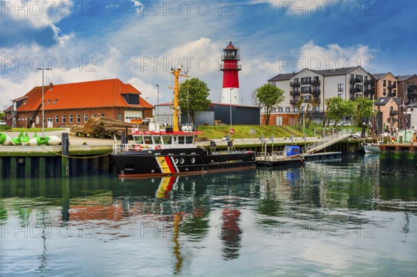 Lighthouse and harbour, ships at the pier, North Sea, Büsum, Schleswig-Holstein, Germany