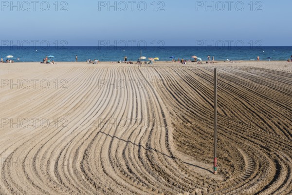 Alicante, Spain, October 13, 2023: Furrows in the sand from sand cleaning raking in the beach of San Juan