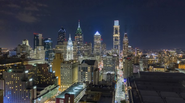 Aerial view night sky over the neighborhoods and streets of Philadelphia PA USA