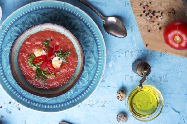Classic spanish raw eating cold soup Gazpacho served at blue table. flat lay. food recipe. healthy concept