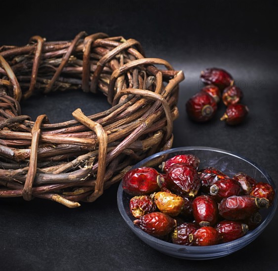 Rose in white bowl on background licorice root bound in coil