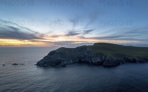 Sunset over the Atlantic Ocean and the cliffs of Bray Head on Valentia Island in County Kerry of western Ireland