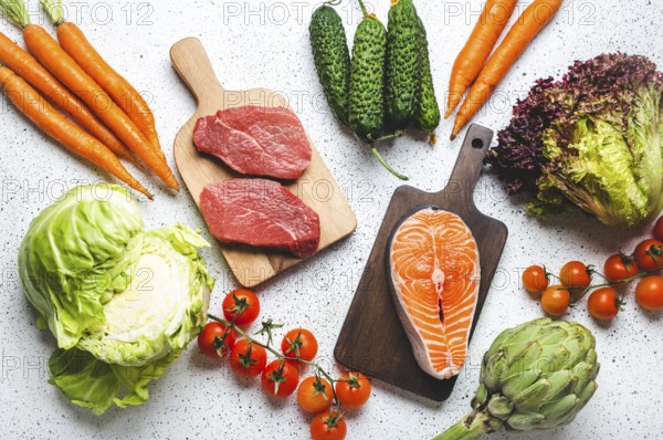 Assorted food raw products: vegetables, beef meat steak, fish salmon fillet on wooden cutting boards, white rustic table top view. Healthy food ingredients background, diet and balanced nutrition, food photography, food photography