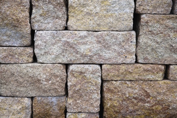 Rough stones layered as privacy screen and background - brown stone wall, pattern