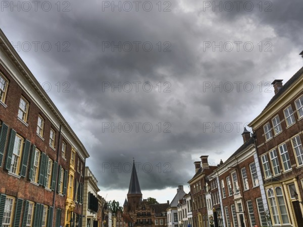 Wide street view with historic houses and dramatic clouds in the sky, zutphen, gelderland, netherlands
