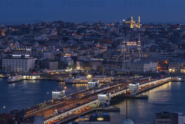 A picture of the Galata Bridge, with the New Mosque and the Nuruosmaniye Mosque, at night